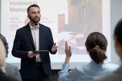 a man in a suit giving a presentation to a woman