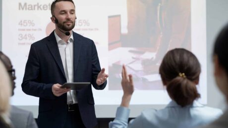 a man in a suit giving a presentation to a woman