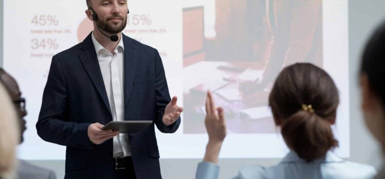 a man in a suit giving a presentation to a woman